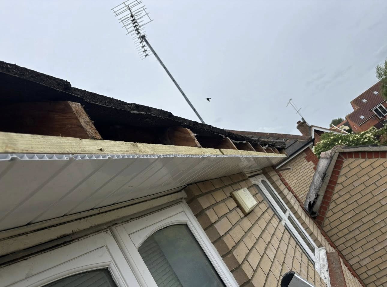 Black fascia and guttering on a brick home