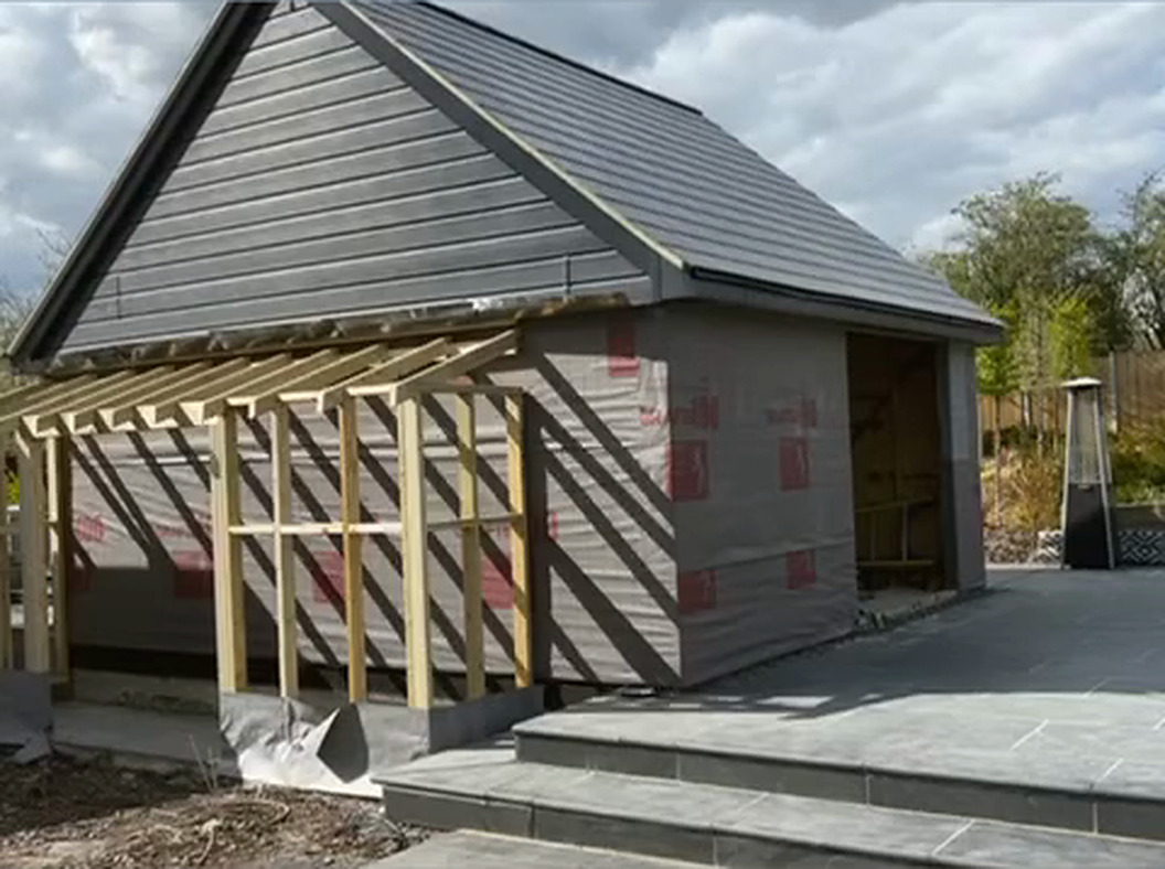 Walls wrapped and clad, canopy framed out