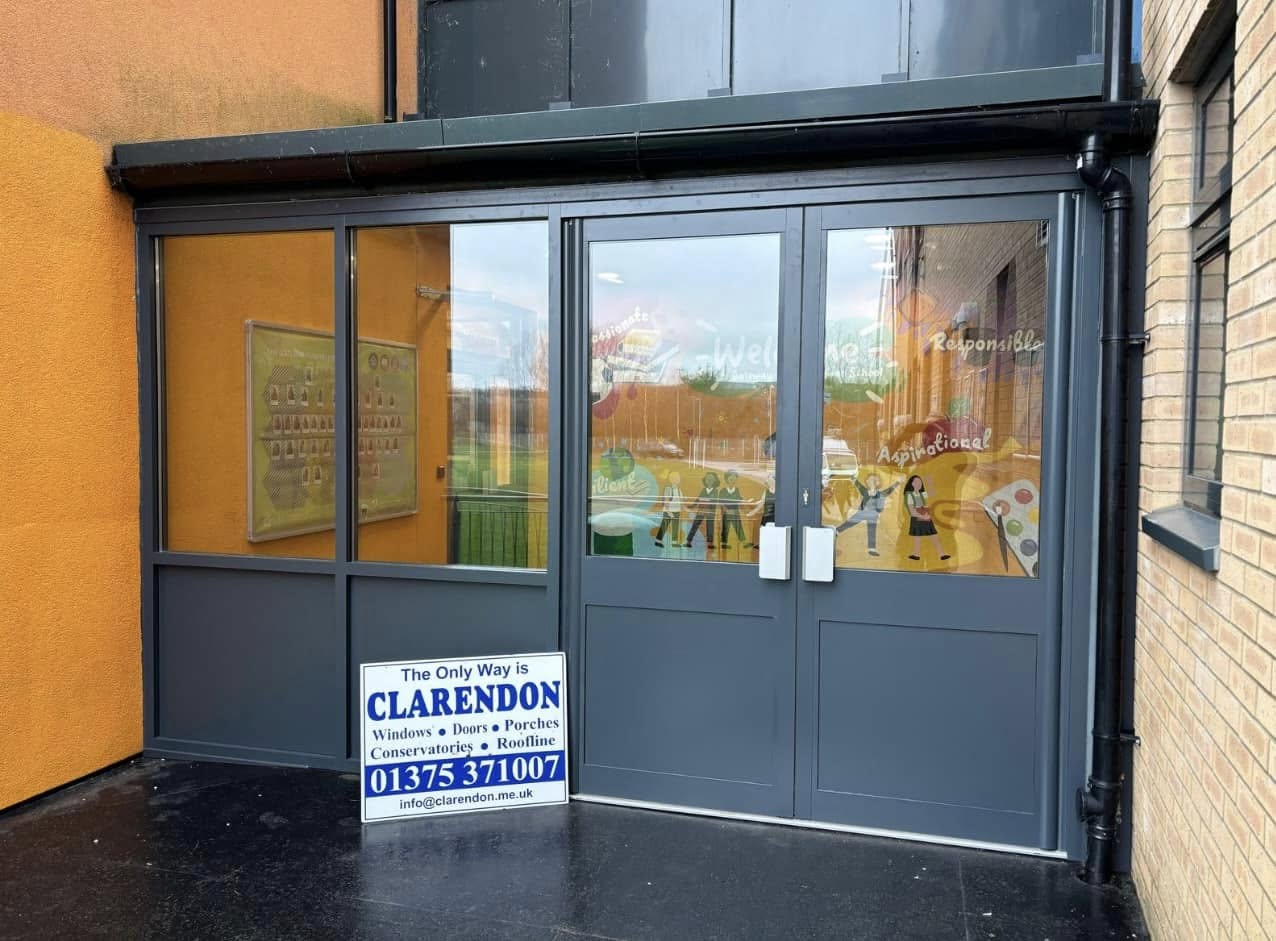 Anthracite grey aluminium commercial entrance doors with full-height glazing