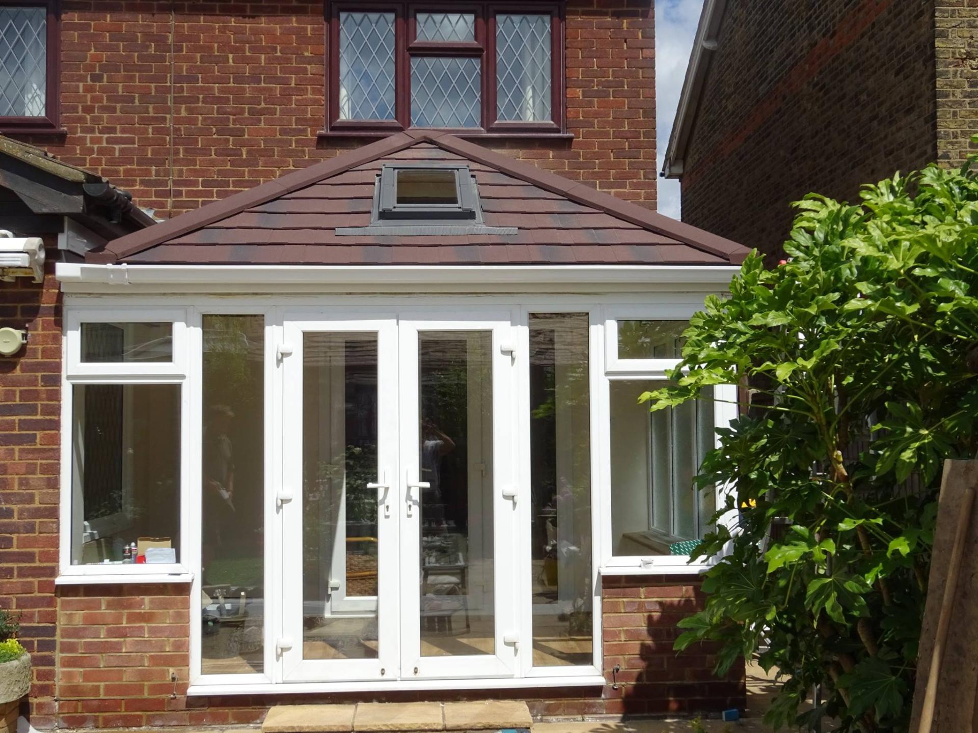White uPVC French doors on a conservatory with tiled roof