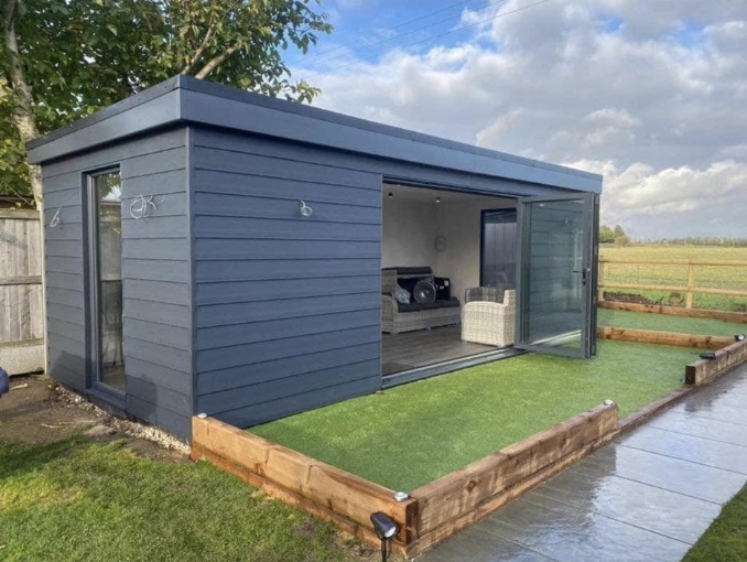 Insulated garden room overlooking a landscaped pond