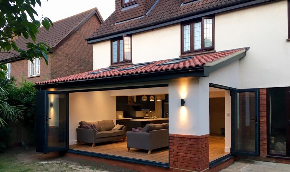 A single-storey rear extension with anthracite bi-fold doors open to a living and kitchen space