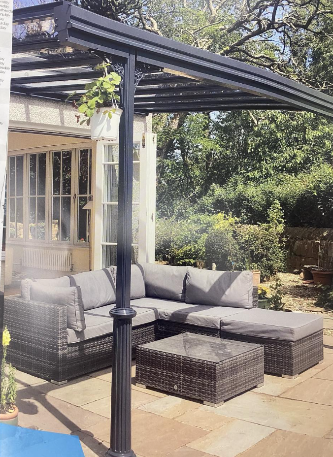 Glass-roofed veranda over a garden seating area